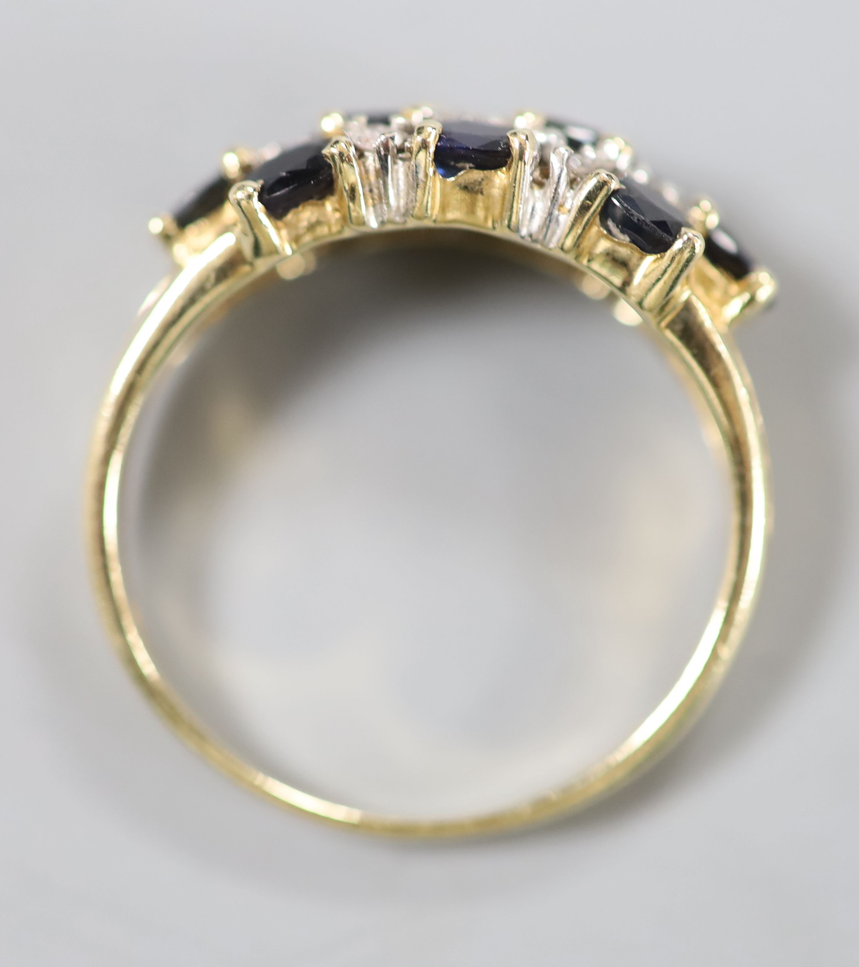 A modern 14ct gold, sapphire and diamond cluster half hoop dress ring, size Q, gross 4 grams.